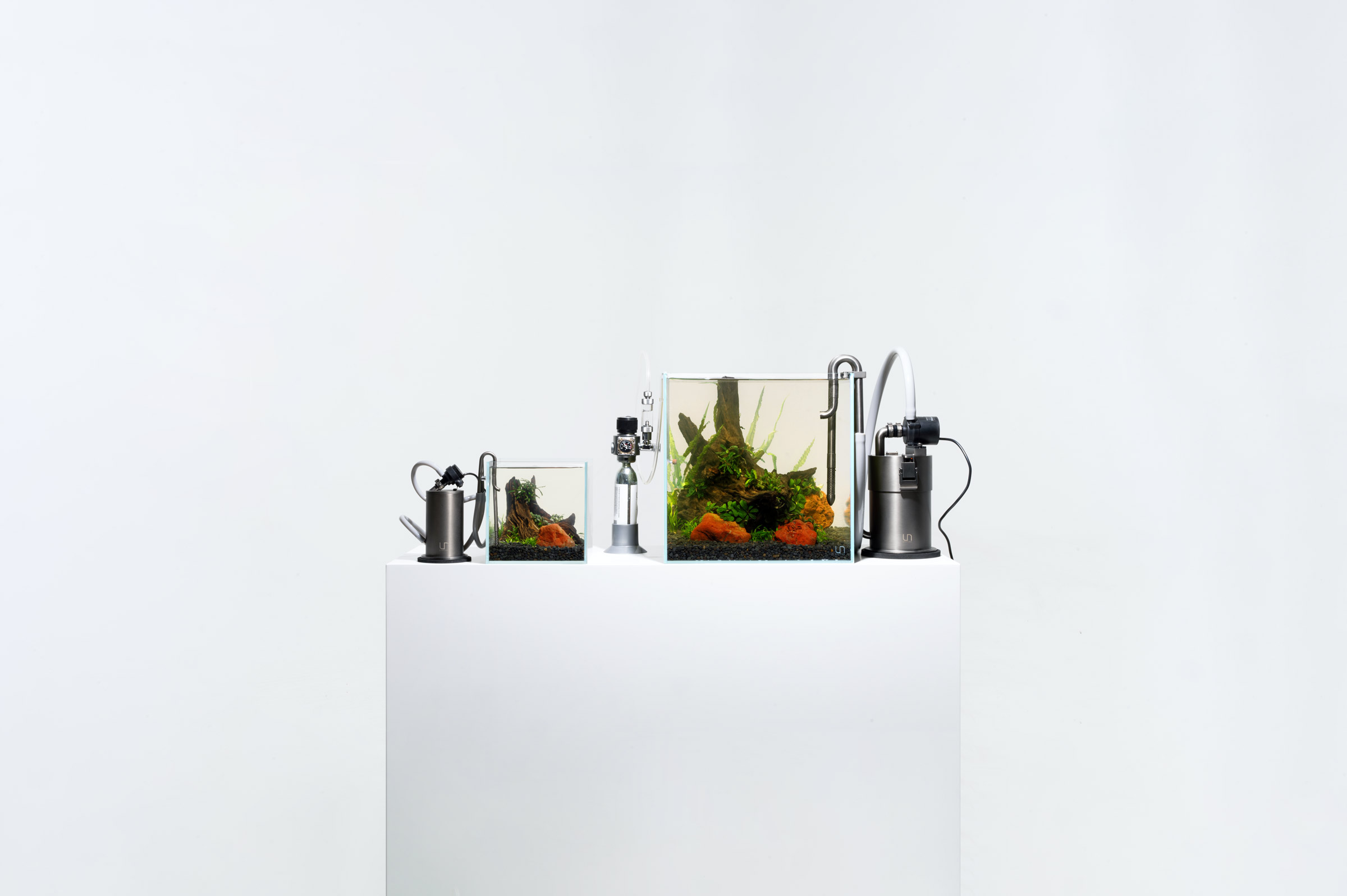 Ultum Nature Systems UNS stand with two rimless 16C and 30C tanks with 6 oz. and 32 oz. UNS Blitz stainless steel canister filters installed along with the mini CO2 system.